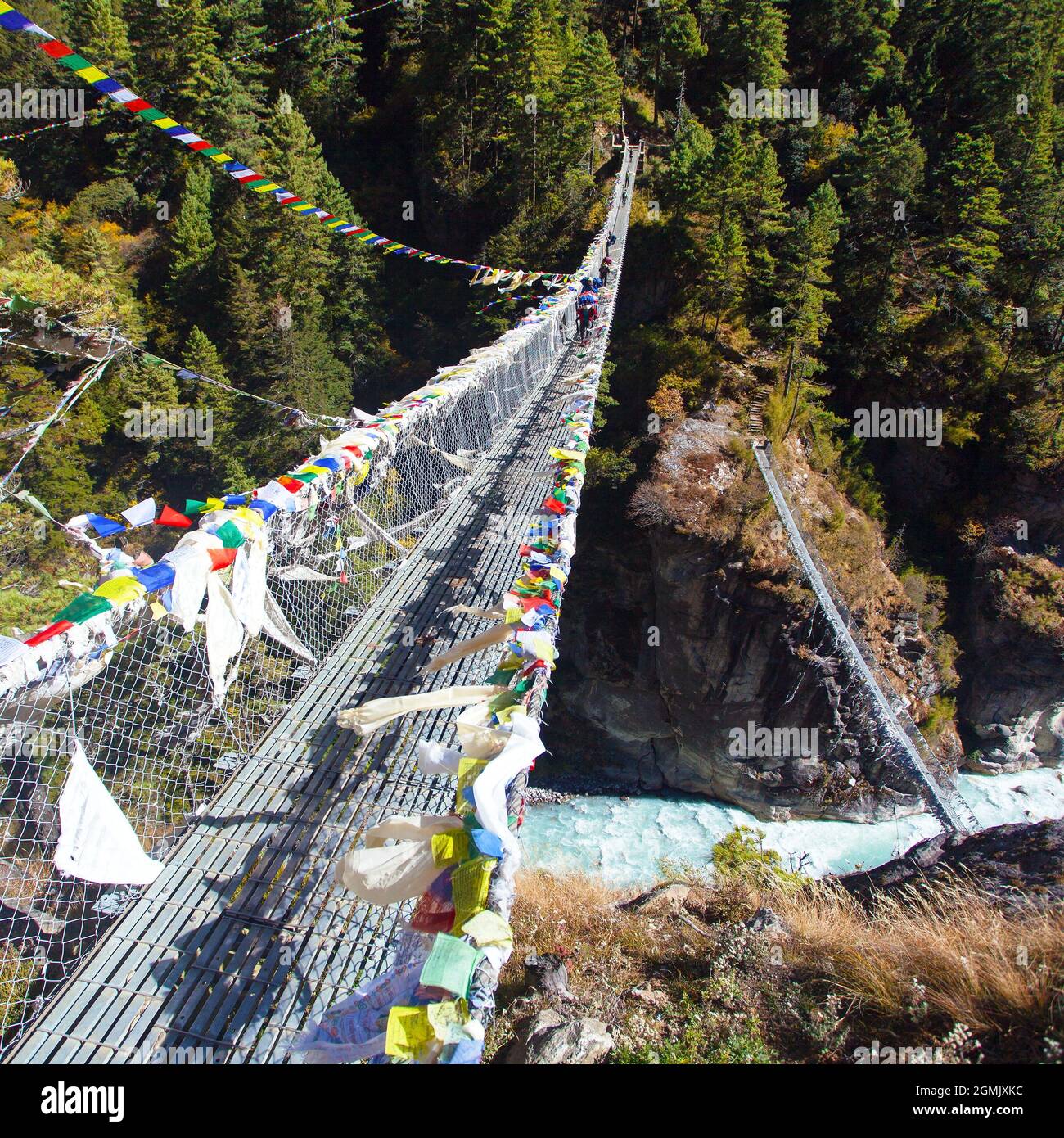 Cross the Dudh Koshi suspension bridges