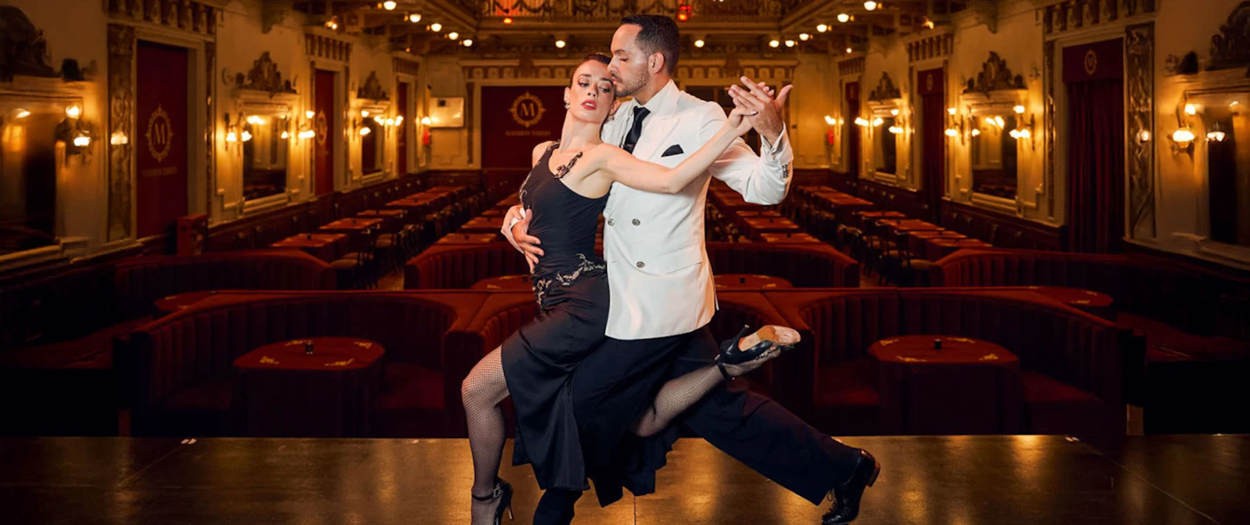 A collection of tango-themed artwork lines the walls of the venue. It highlights the cultural history of the dance in Argentina.