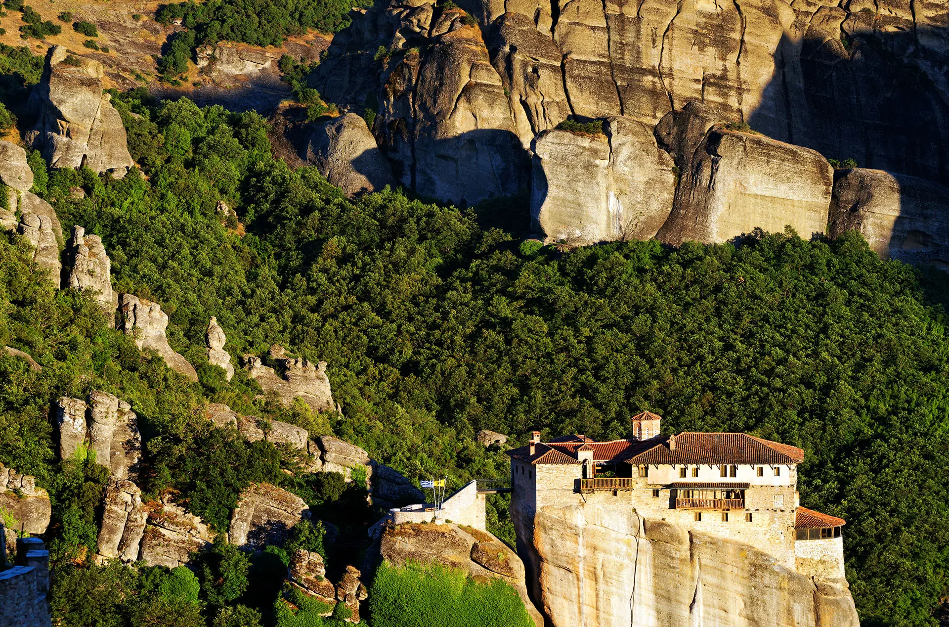 Home to a massive barrel for wine storage and intricate frescoes, sitting atop a towering rock pillar.